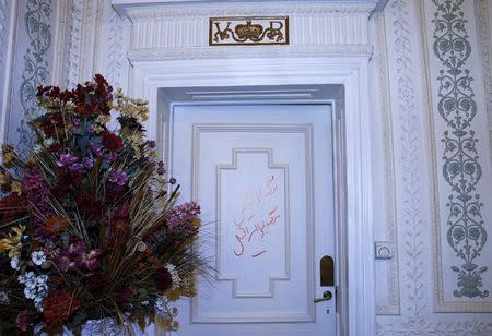 Graffiti in Persian reading "Death to England" is seen on a door inside the British Embassy in Tehran, Iran August 23, 2015. REUTERS/Darren Staples