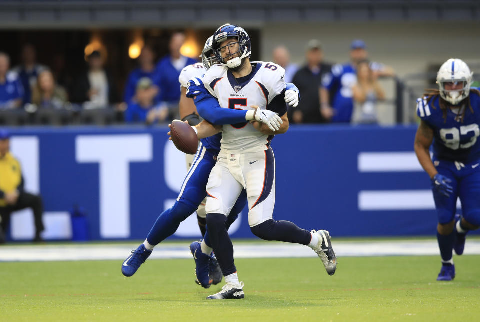 Joe Flacco is sacked in a loss to the Colts. (Getty Images)