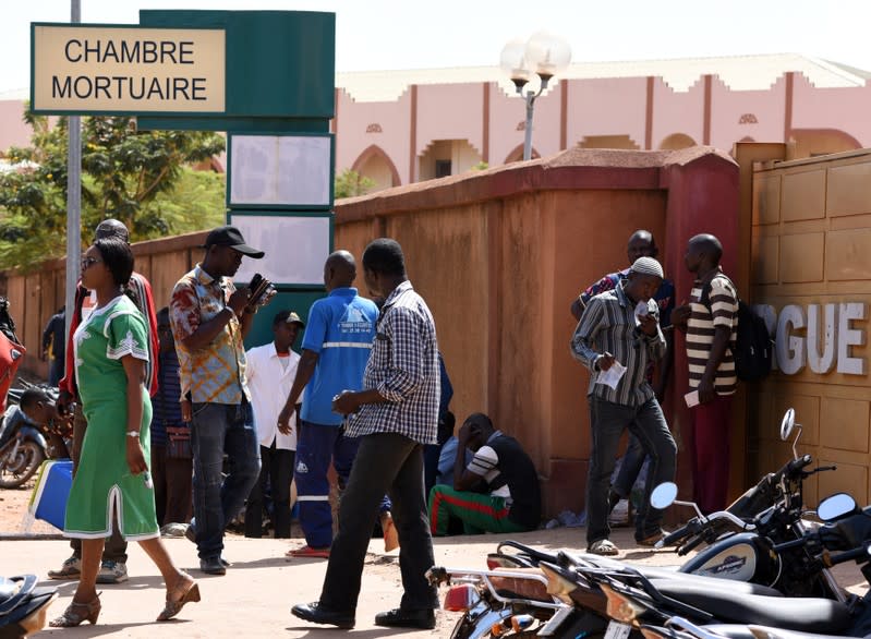 Relatives of victims of an attack on a road leading to the Boungou mine, operated by Canadian gold miner Semafo, wait outside a morgue in Ouagadougou