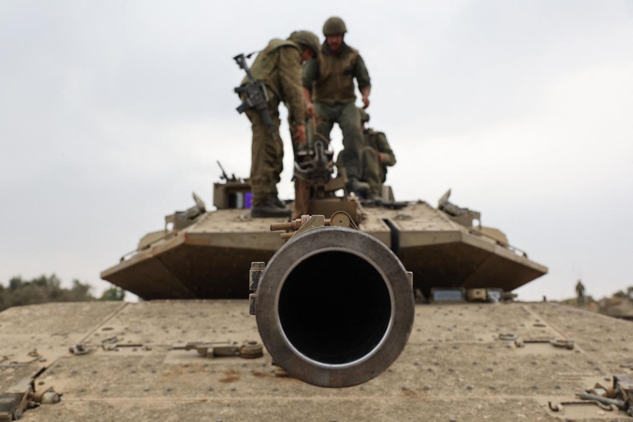 Israeli army soldiers are positioned with their Merkava tanks near the border with the Gaza Strip in southern Israel on 9 October 2023 (AFP via Getty Images)