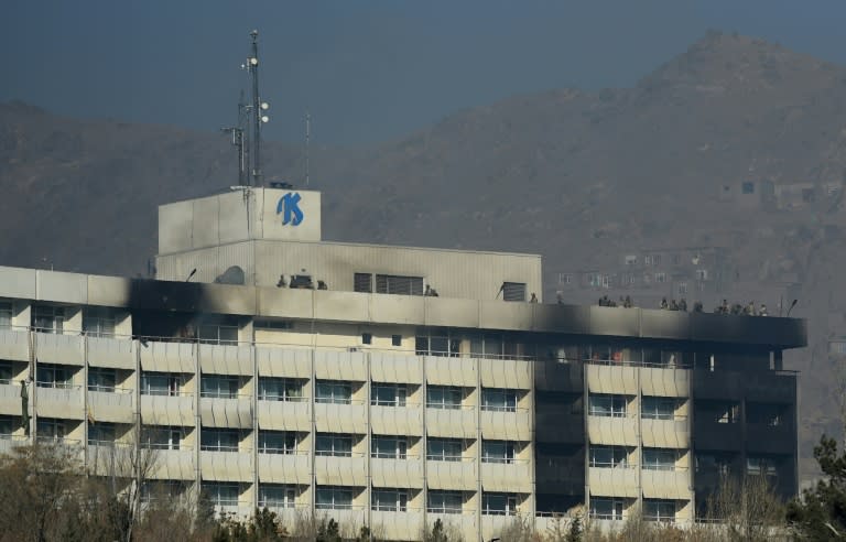 Afghan security personnel took positions on the roof of the Intercontinental Hotel during the fight between gunmen and security forces