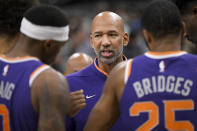 Phoenix Suns head coach Monty Williams, center, talks to his players during the second half of an NBA basketball game against the San Antonio Spurs, Saturday, Jan. 28, 2023, in San Antonio. (AP Photo/Darren Abate)