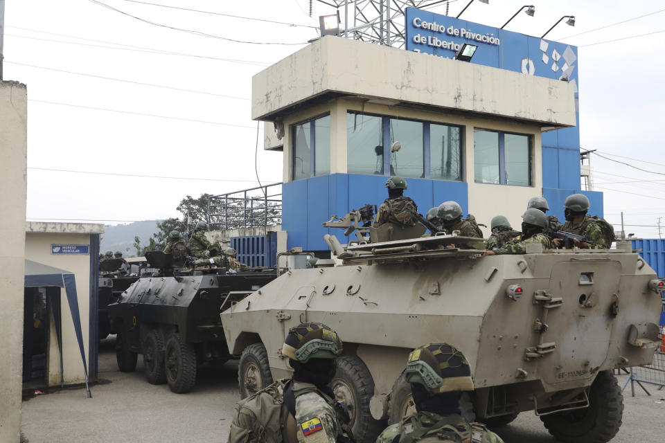 FILE - Armored vehicles enter the Deprivation of Liberty Center of the Zone 8 in Guayaquil, Ecuador, Aug. 12, 2023. Military personnel entered the facility to transfer Adolfo Macias, alias "Fito" considered the head of Los Choneros, an organized crime group. Slain presidential candidate Fernando Villavicencio had accused Macias of having threatened him. (AP Photo/Cesar Munoz, File)