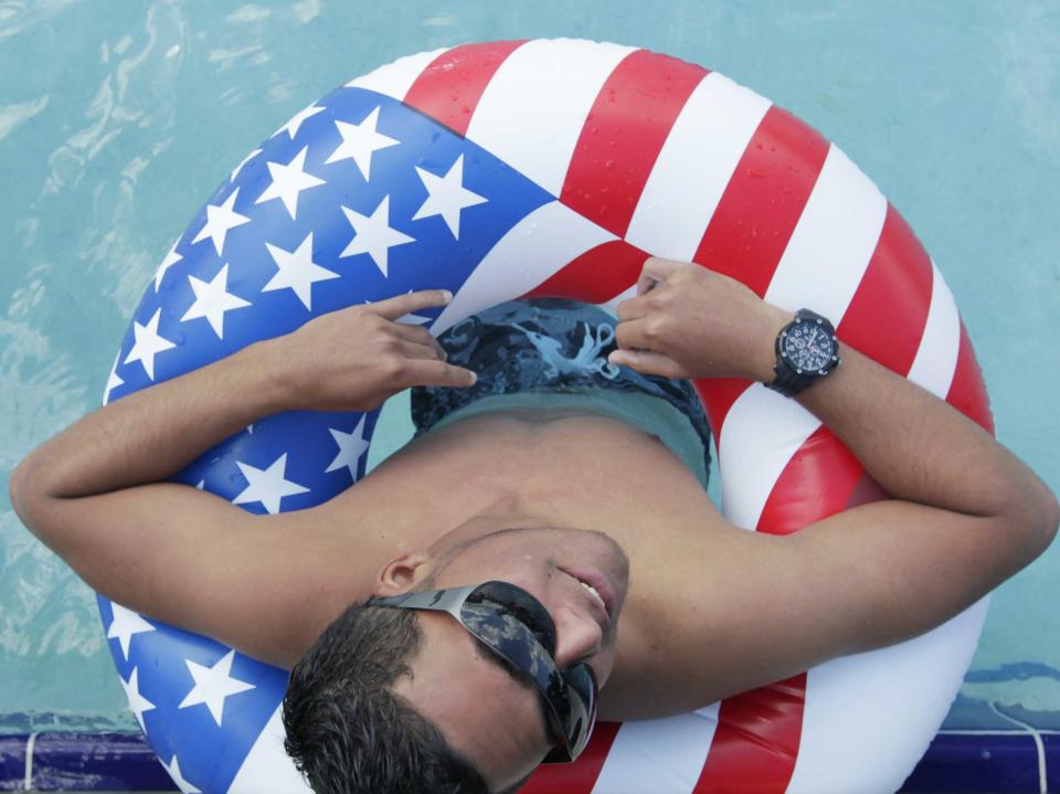 man wearing sunglasses in american flag innertube 