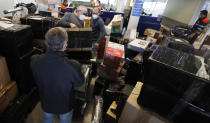 People check in luggages at the Vaclav Havel airport after a Russian special government plane landed in Prague, Czech Republic, Monday, April 19, 2021. Czech Republic is expelling 18 diplomats identified as spies over a 2014 ammunition depot explosion. On Saturday, April 17, 2021, Prime Minister Andrej Babis said the Czech spy agencies provided clear evidence about the involvement of Russian military agents in the massive explosion that killed two people. (AP Photo/Petr David Josek)