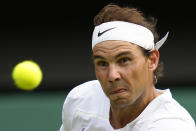Spain's Rafael Nadal eyes the ball as he plays Taylor Fritz of the US in a men's singles quarterfinal match on day ten of the Wimbledon tennis championships in London, Wednesday, July 6, 2022. (AP Photo/Kirsty Wigglesworth)