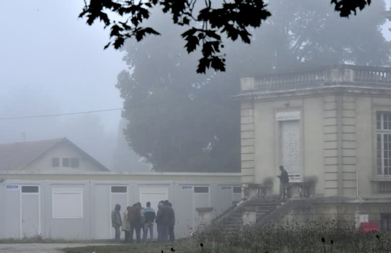 Sudanese migrants, who arrived from the Calais ''Jungle'' camp, stand near temporary accommodations set up in front of the Chateau des Arts in Talence, one of the housing sites for migrants who left Calais, on October 25, 2016