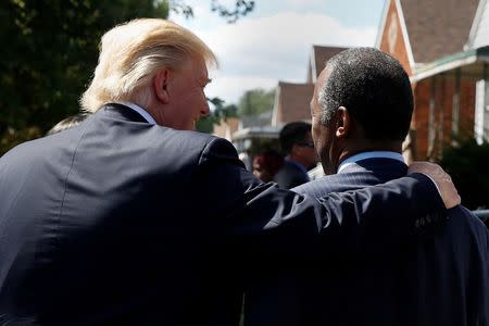 Republican presidential then nominee Donald Trump and Ben Carson walk to Carson's childhood home in Detroit, Michigan, U.S. September 3, 2016. REUTERS/Carlo Allegri/ File photo