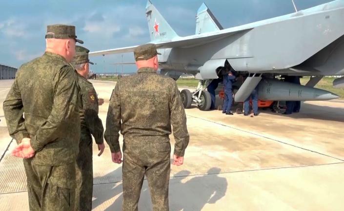 <div class="inline-image__title">Russia Syria Drills</div> <div class="inline-image__caption"><p>Russian Defense Minister Sergei Shoigu, center, and others stand near a MiG-31 fighter of the Russian air force carrying a Kinzhal hypersonic cruise missile in Syria.</p></div> <div class="inline-image__credit">AP</div>