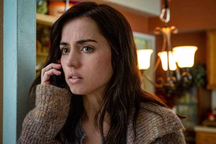 Ana de Armas, with a concerned expression, talks on the phone in a scene from "Knives Out"