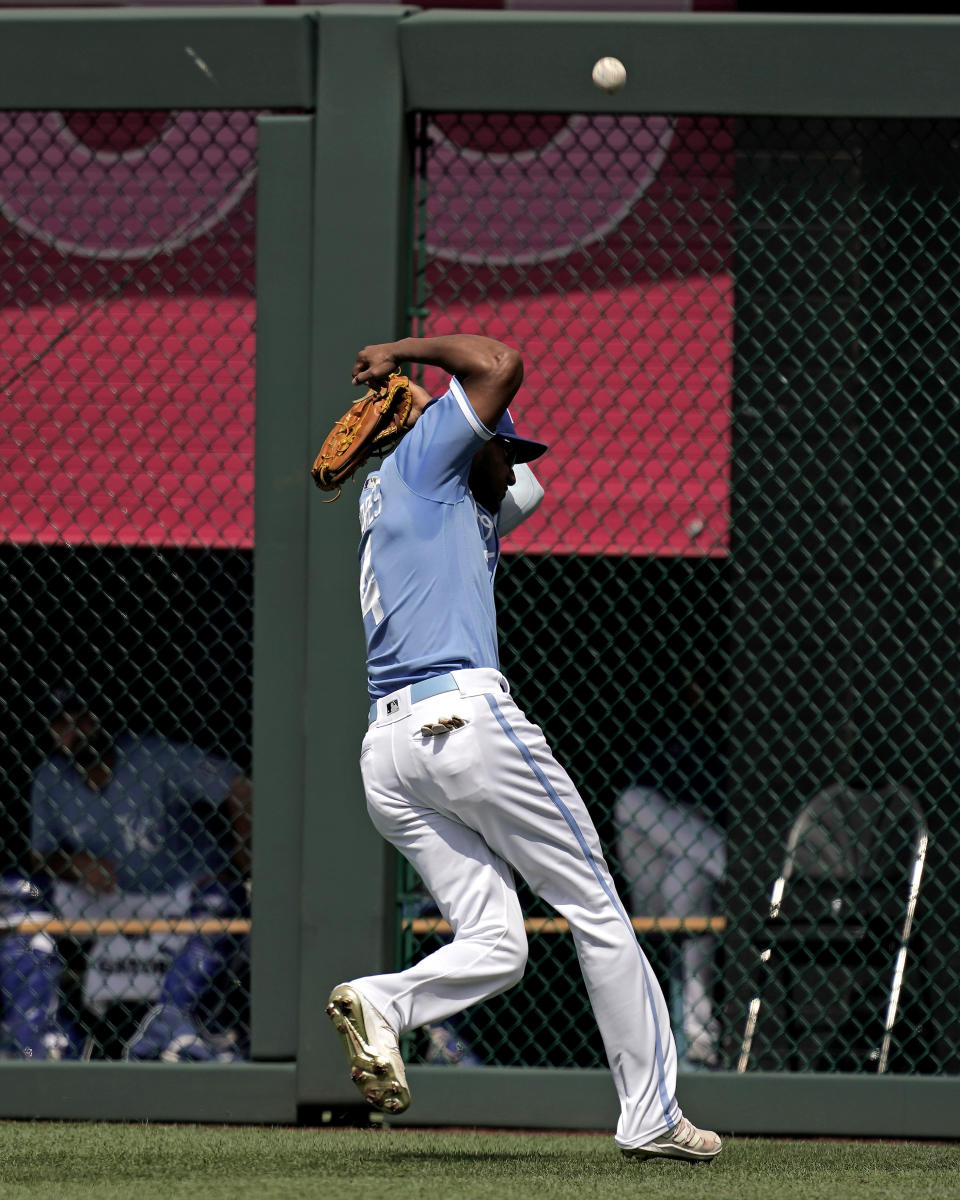 Kansas City Royals right fielder Edward Olivares ducks to avoid being hit by a ball hit by Oakland Athletics' Tony Kemp for a double during the third inning of a baseball game Saturday, June 25, 2022, in Kansas City, Mo. (AP Photo/Charlie Riedel)