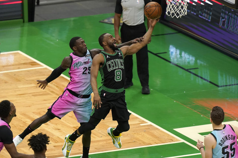 Boston Celtics' Kemba Walker (8) drives toward the basket as Miami Heat's Kendrick Nunn (25) tries to block in the second half of a basketball game, Sunday, May 9, 2021, in Boston. (AP Photo/Steven Senne)
