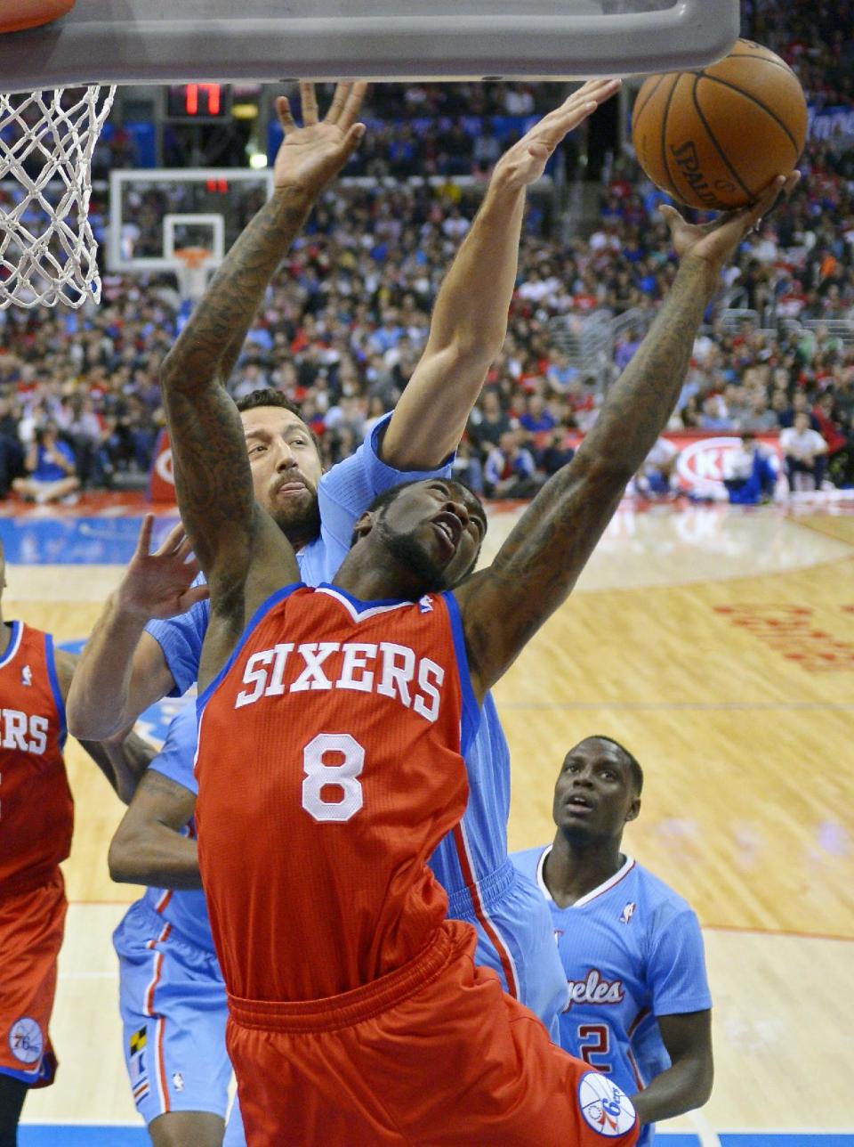 Philadelphia 76ers guard Tony Wroten, right, puts up a shot as Los Angeles Clippers forward Hedo Turkoglu, of Turkey, defends during the first half of an NBA basketball game, Sunday, Feb. 9, 2014, in Los Angeles. (AP Photo/Mark J. Terrill)