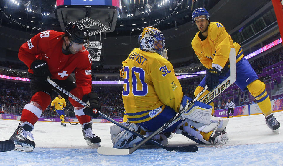 Switzerland forward Kevin Romy (88) and Sweden defenseman Niklas Hjalmarsson look for the rebound behind goaltender Henrik Lundqvist in the third period of a men's ice hockey game at the 2014 Winter Olympics, Friday, Feb. 14, 2014 in Sochi, Russia. Sweden won 1-0. (AP Photo/Mark Blinch, Pool)