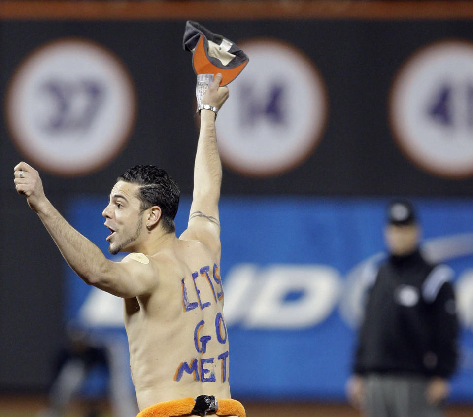 A man with runs on the field during the fifth inning of a baseball game between the New York Mets and the Atlanta Braves on Tuesday, May 12, 2009, at Citi Field in New York. (AP Photo/Frank Franklin II)