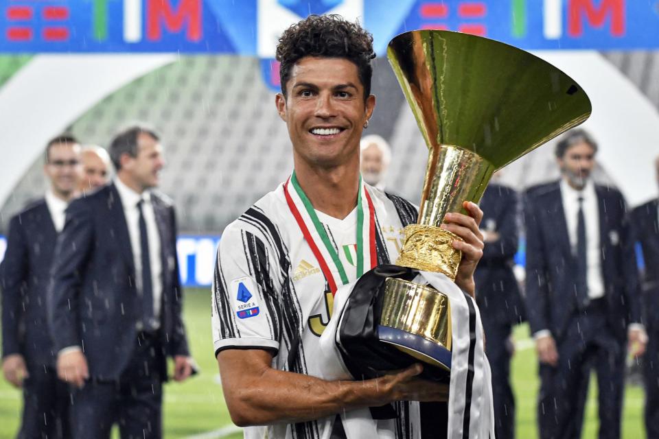 <p>Soccer superstar Cristiano Ronaldo holds up a trophy in celebration of winning the Serie A title in Turin, Italy, on Sunday. </p>