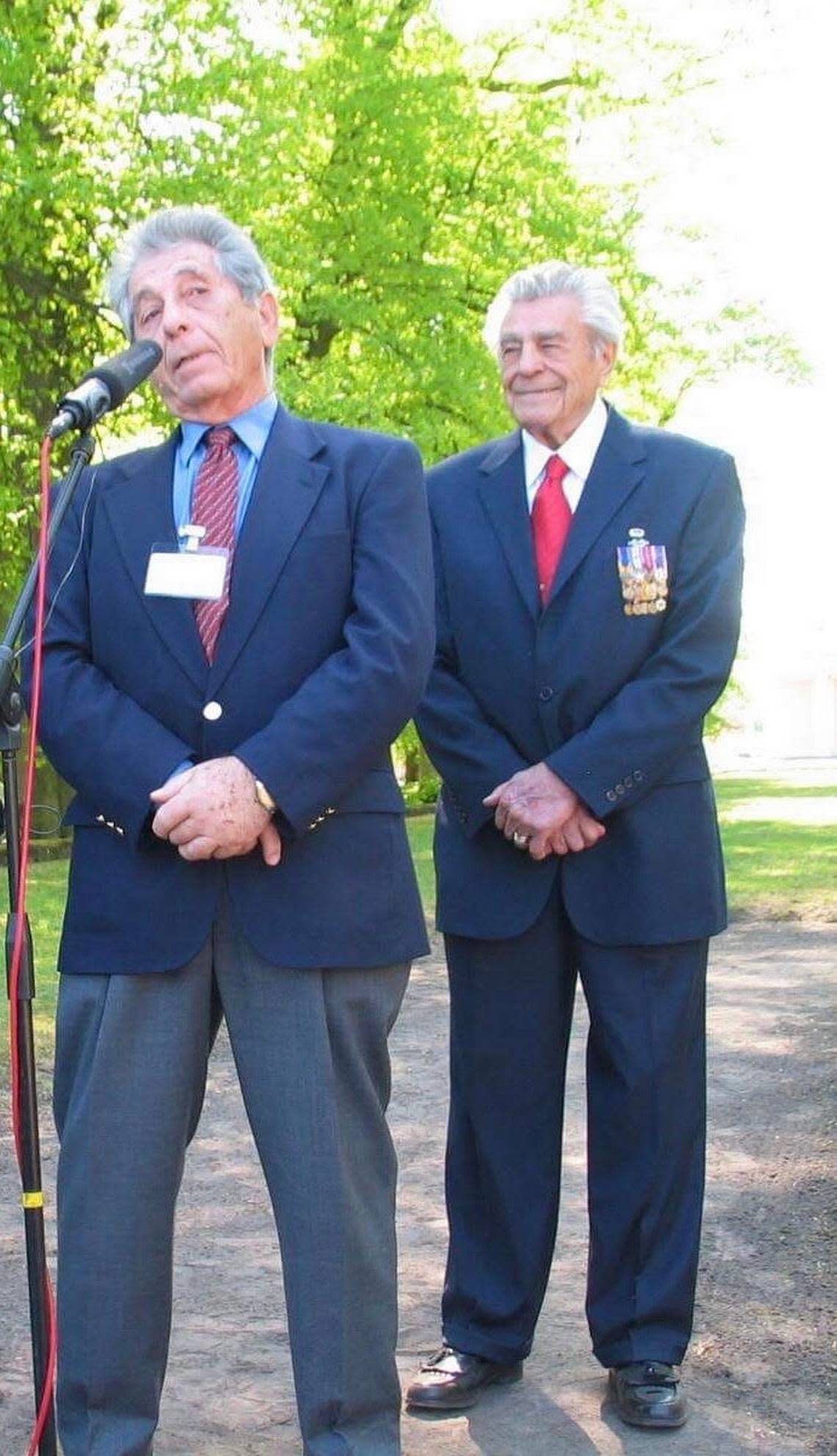 George Salton, left, and James Megellas attend a memorial service in 2007 at the Wöbbelin concentration camp, marking 62 years since its liberation. Megellas, a decorated member of the 82nd U.S. Army Airborne Division, was among the liberators.
