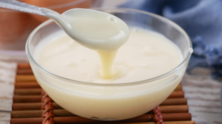 Bowl of condensed milk with spoon