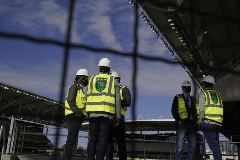 Dignitaries gather for a ribbon cutting at Austin FC's new stadium under construction which has been named Q2 Stadium, Monday, Jan. 25, 2021, in Austin, Texas. (AP Photo/Eric Gay)