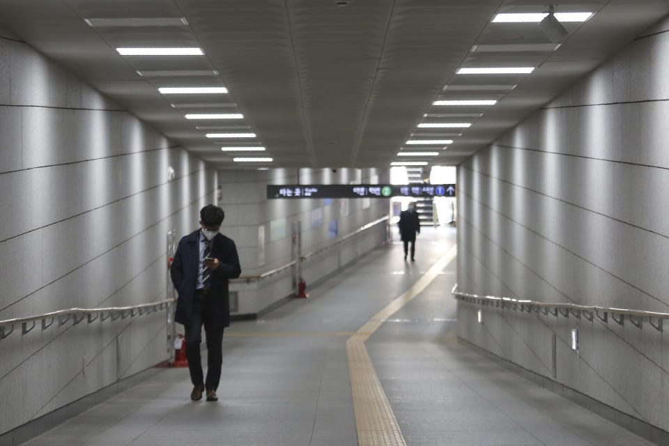 A man wearing a face mask to help protect against the spread of the new coronavirus walks on the underpass in Seoul, South Korea, Thursday, April 2, 2020. For most people, the new coronavirus causes only mild or moderate symptoms, such as fever and cough. For some, especially older adults and people with existing health problems, it can cause more severe illness, including pneumonia. (AP Photo/Ahn Young-joon)