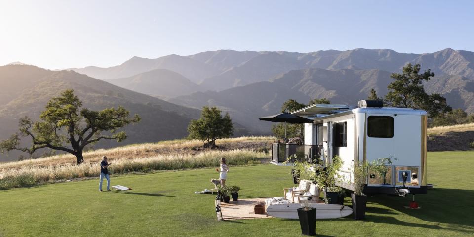 the 2022 Living Vehicle trailer outside on a patch of grass with an outdoor setup