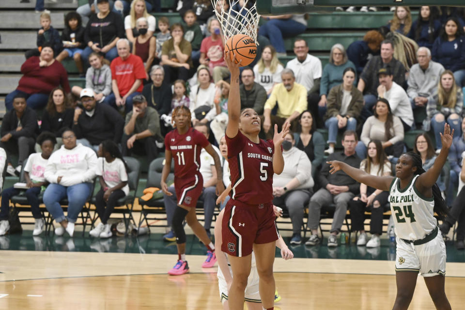 South Carolina forward Victaria Saxton (5) scores as Cal Poly guard Oumou Toure (24) watches in the first half of an NCAA college basketball game, Tuesday, Nov. 22, 2022, San Luis Obispo, Calif. (AP Photo/Nic Coury)