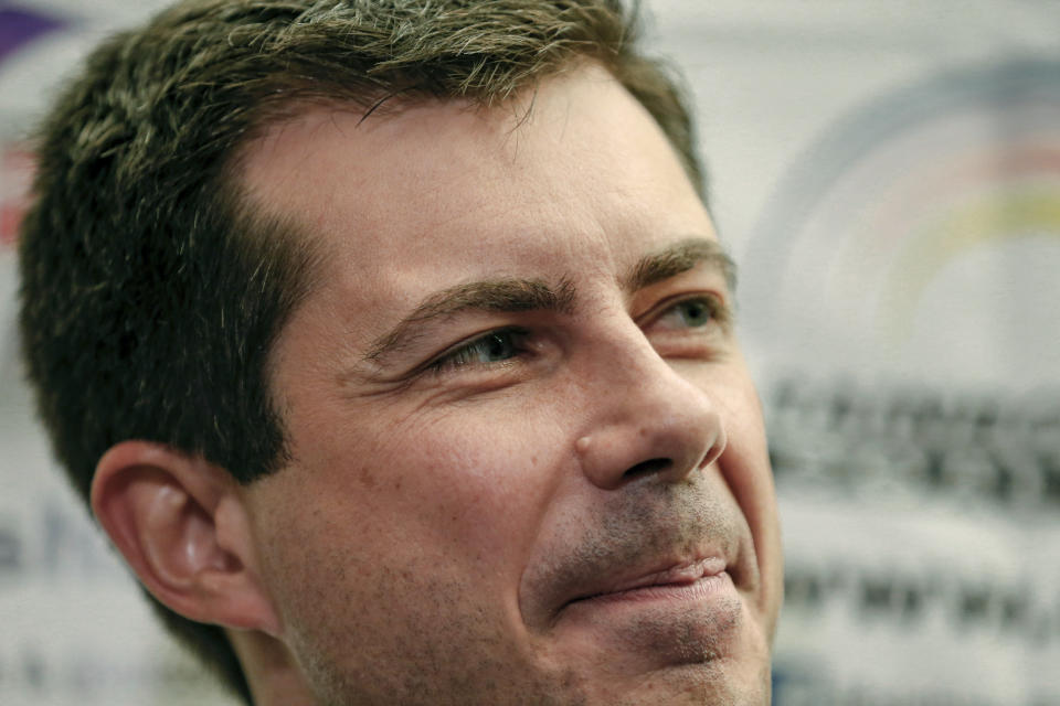 In this July 2, 2019 photo, Democratic presidential candidate and South Bend, Ind., Mayor Pete Buttigieg, listens as Rev. Jesse Jackson, not pictured, addresses reporters during a news conference at the Rainbow PUSH Coalition Annual International Convention in Chicago. Buttigieg has money _ far more than the mayor of South Bend, Indiana, expected to have at this stage of the Democratic presidential primary. Now he needs to turn that money into a formidable campaign to ensure his support from donors is matched by backing from voters. (AP Photo/Amr Alfiky)