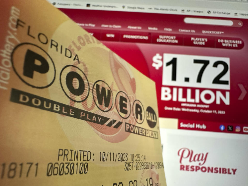 A Powerball lottery ticket is shown, Wednesday, Oct. 11, 2023, in Surfside, Fla. After 35 straight drawings without a big winner, Powerball players are lining up for a shot at a near-record jackpot worth an estimated $1.73 billion. (AP Photo/Wilfredo Lee)