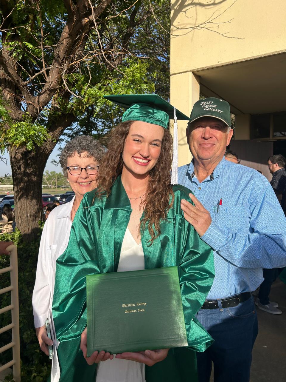 Memphis' Maggie Cook (center) poses with her grandparents Vicky Cook (left) and Randy Cook after receiving her associates degree from Clarendon College in 2023.