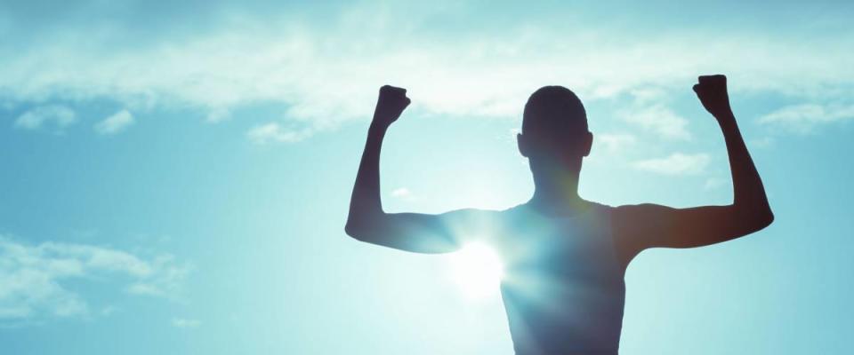 Girl power! Strong and confident woman flexing her muscle.