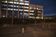 Greek forensic experts search at the scene after a powerful bomb exploded outside private Greek television station, in Faliro, Athens, Monday, Dec, 17, 2018. Police said the blast occurred outside the broadcasters' headquarters near Athens after telephoned warnings prompted authorities to evacuate the building, causing extensive damage but no injuries. (AP Photo/Petros Giannakouris)