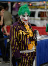 Adam Galloway strikes a pose as the "Joker from Arkum City," as thousands of fiction fans from near and far gather at the Salt Palace Convention Center in Salt Lake City, Utah, Friday, April 18, 2014, for day two of Salt Lake Comic Con's FanX. (AP Photo/The Salt Lake Tribune, Francisco Kjolseth)