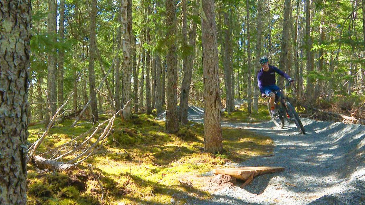 Charlie Côté of Glovertown pedals through the new mountain biking trail at Terra Nova National Park. (Troy Turner/CBC - image credit)