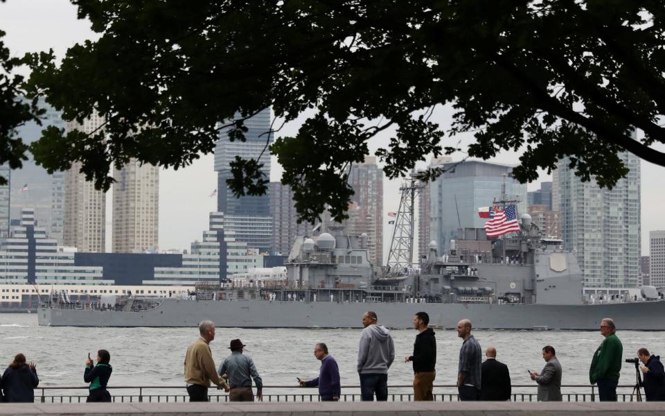 Spectators watch as a vessel arrives for Fleet Week in New York - Credit: Reuters