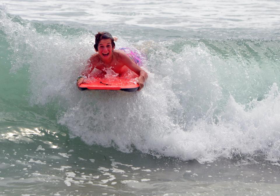 Lou Matz of Stockton used a Nikon D5100 DSLR camera to photograph his 13-year-old son Tyler DiGuilio-Matz as he catches a wave at  Huntington Beach.