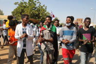 Sudanese gather at a protest, in Khartoum, Sudan, Wednesday, Oct. 21, 2020. Protesters have taken to the streets in the capital and across the country over dire living conditions and a deadly crackdown on demonstrators in the east earlier this month. Sudan is currently ruled by a joint civilian-military government, following the popular uprising that toppled longtime autocrat Omar al-Bashir last year. (AP Photo/Marwan Ali)