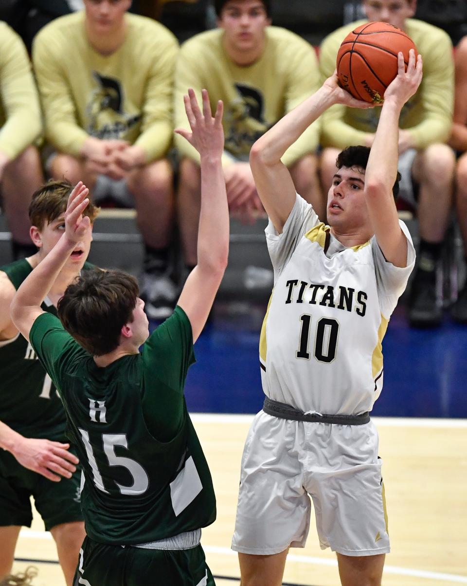 Avoca/Prattsburgh's Haden Abbott, right, takes a shot over Hamilton's Bryce Wright during a NYSPHSAA Class D Boys Basketball Championship semifinal in Glens Falls, N.Y., Saturday, March 18, 2023. Avoca/Prattsburgh advanced to the Class D final with a 64-41 win over Hamilton-III.