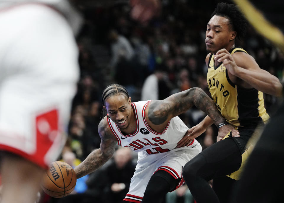 Chicago Bulls' DeMar DeRozan protects the ball from Toronto Raptors' Scottie Barnes (4) during the first half of an NBA basketball In-Season Tournament game Friday, Nov. 24, 2023, in Toronto. (Frank Gunn/The Canadian Press via AP)