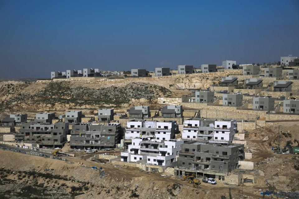 Houses under construction on an arid hilltop in the West Bank