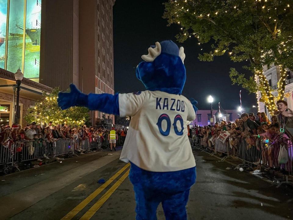 Blue Wahoos mascot Kazoo greets throngs of parade spectators during the Pensacola Christmas Parade on December 10.