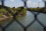 A canal carries water from the Cameron County Irrigation District #2 pump station, Wednesday, Sept. 15, 2021, in San Benito, Texas. Canals used to deliver water in many parts of the Rio Grande Valley lose anywhere from 10% to 40% of the water they carry to seepage and evaporation, according to the Texas Water Development Board, making water a growing concern amid climate change and rising demand that scientists predict will lead to water shortages in the region by 2060. (AP Photo/Eric Gay)