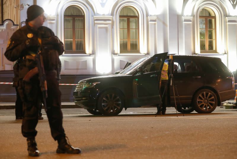 An investigator inspects a car at a site of a murder attempt on Viacheslav Soboliev in Kiev