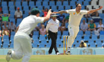 Australia's bowler Mitchell Johnson, right, celebrates his wicket as umpire Aleem Dar, center, of Pakistan watches on the fourth day of their their cricket test match against South Africa at Centurion Park in Pretoria, South Africa, Saturday, Feb. 15, 2014. (AP Photo/ Themba Hadebe)