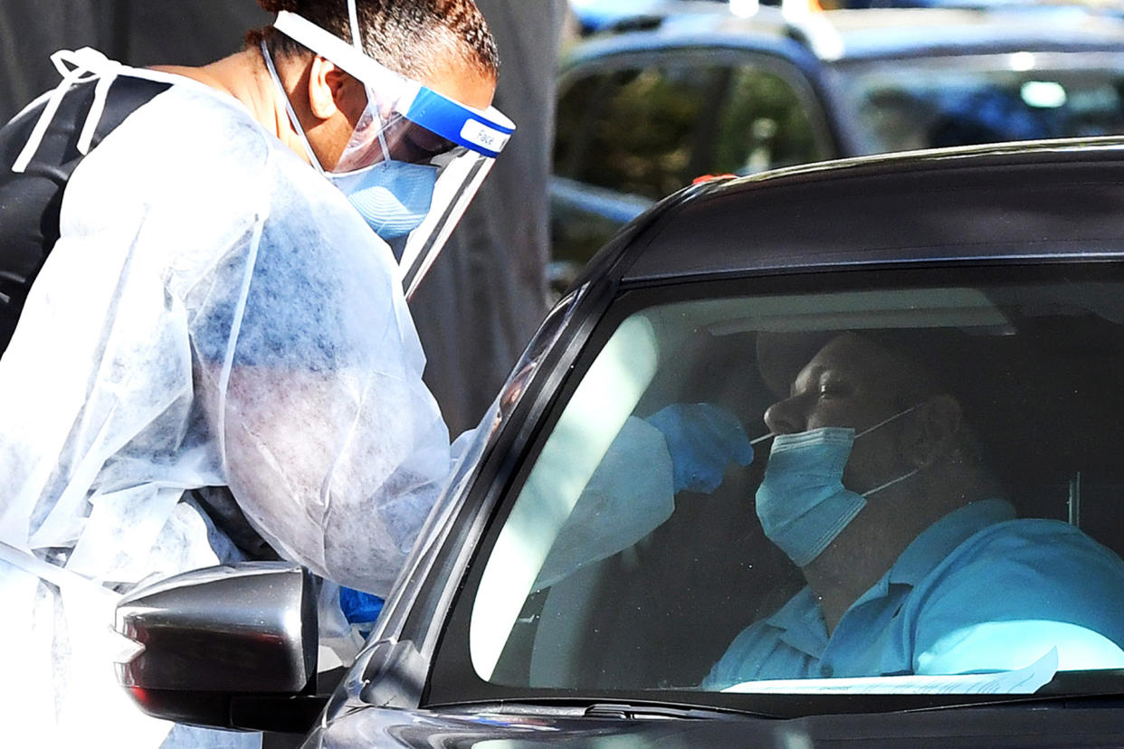 A health worker performs a nasal swab sample at a COVID-19 - Credit: Paul Hennessy/SOPA Images/LightRocket/Getty Images