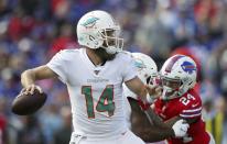 Miami Dolphins quarterback Ryan Fitzpatrick drops back to pass under pressure from Buffalo Bills cornerback Taron Johnson, right, in the first half of an NFL football game, Sunday, Oct. 20, 2019, in Orchard Park, N.Y. (AP Photo/Ron Schwane)