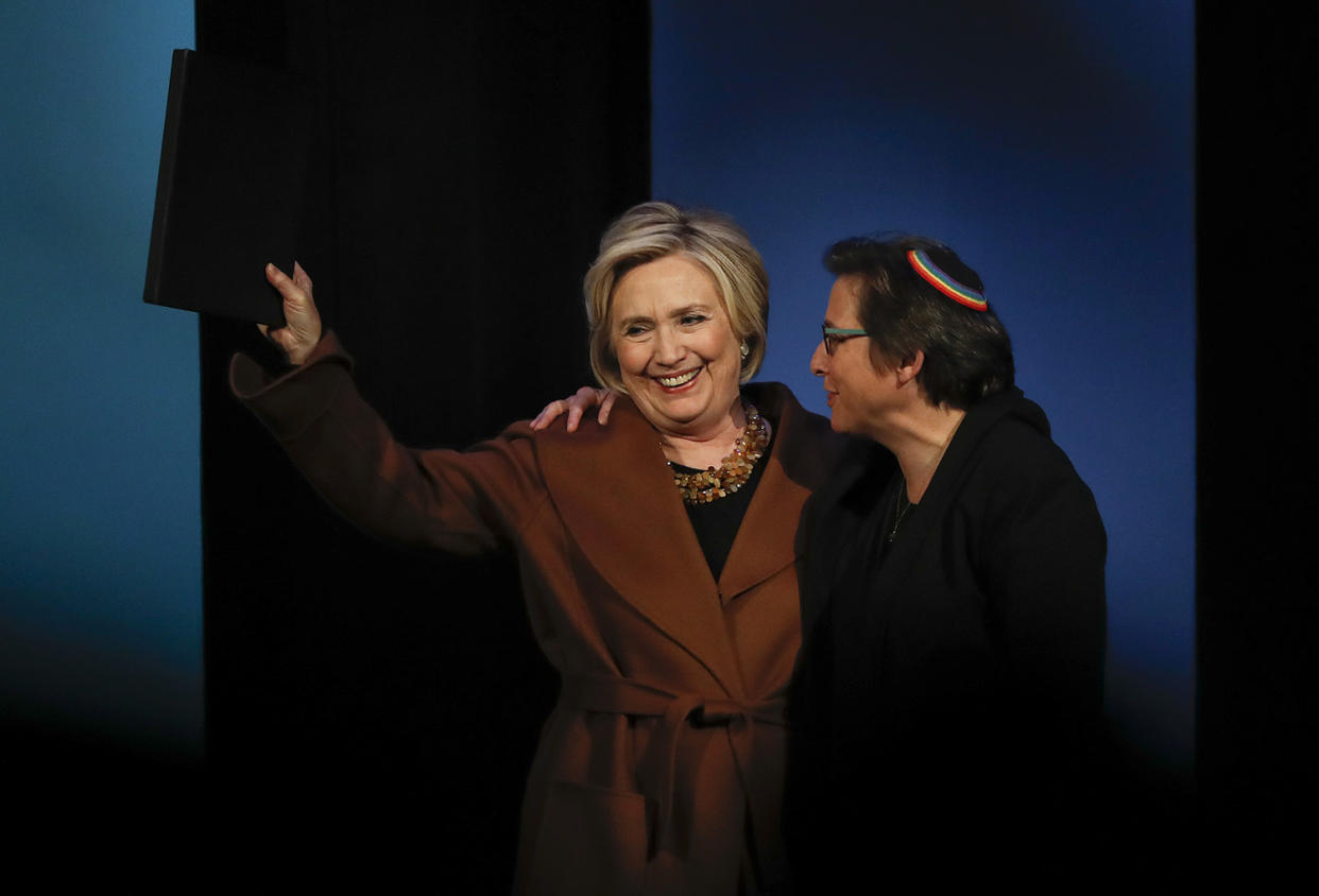 Former Secretary of State Hillary Clinton, left, waves to the crowd after speaking during a benefit to celebrate the 25th anniversary of Rabbi Sharon Kleinbaum, right, and Congregation Beit Simchat Torah, Monday, Dec. 4, 2017, in New York. (Photo: AP/Julie Jacobson)