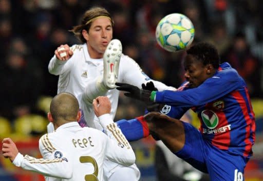 Pepe (L) and Sergio Ramos (C) of Real Madrid fight for the ball against Ahmed Musa (R) of CSKA Moscow during their round of 16, first leg match UEFA Champions League in Moscow. The match ended in a 1-1 draw