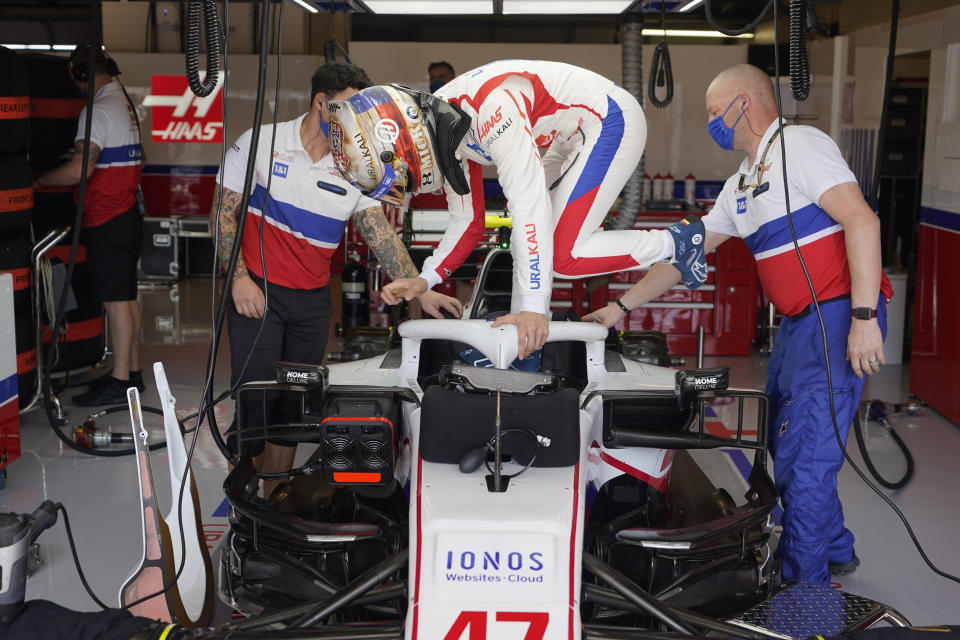 Haas driver Mick Schumacher, of Germany, climbs into his car during a practice session for the F1 US Grand Prix auto race at Circuit of the Americas, Friday, Oct. 22, 2021, in Austin, Texas. (AP Photo/Darron Cummings)