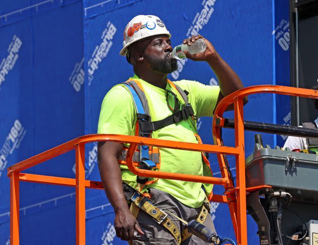 A construction worker stops for a water break while working at a site in Boston last month. An average of 33 heat-related workplace deaths and 3,389 injuries and illnesses occurred each year from 1992 to 2020.