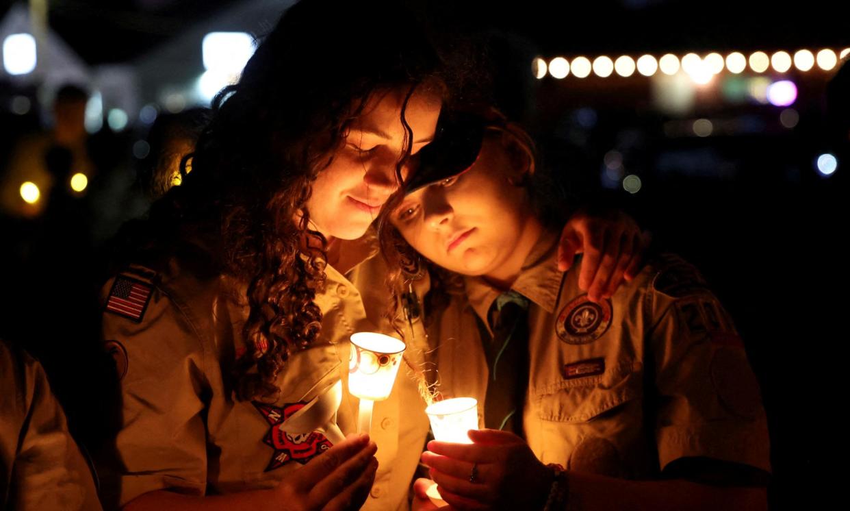 <span>People hold candles during a candlelight vigil for victims of Lewiston mass shooting, in Lisbon, Maine, on 28 October 2023. </span><span>Photograph: Shannon Stapleton/Reuters</span>